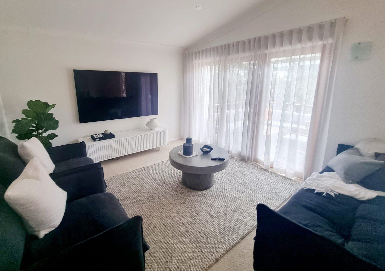 Living Room With Dark Gray Sofas, and Sheer Curtains — Glenn Koek - Shutters - Curtains - Blinds in Sutherland Shire, NSW