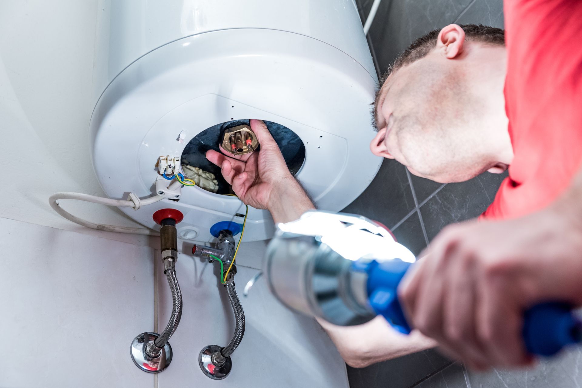 Man fixing heater - Mendon, MA | American Bath Works Man fixing heater - Mendon, MA | American Bath Works
