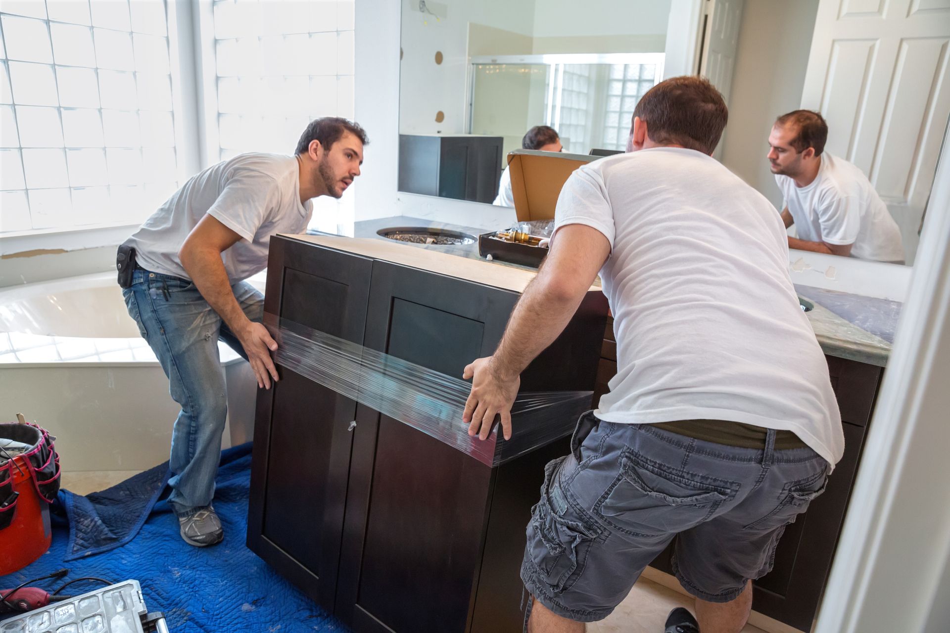 Men moving cupboard - Mendon, MA | American Bath Works Men moving cupboard - Mendon, MA | American Bath Works