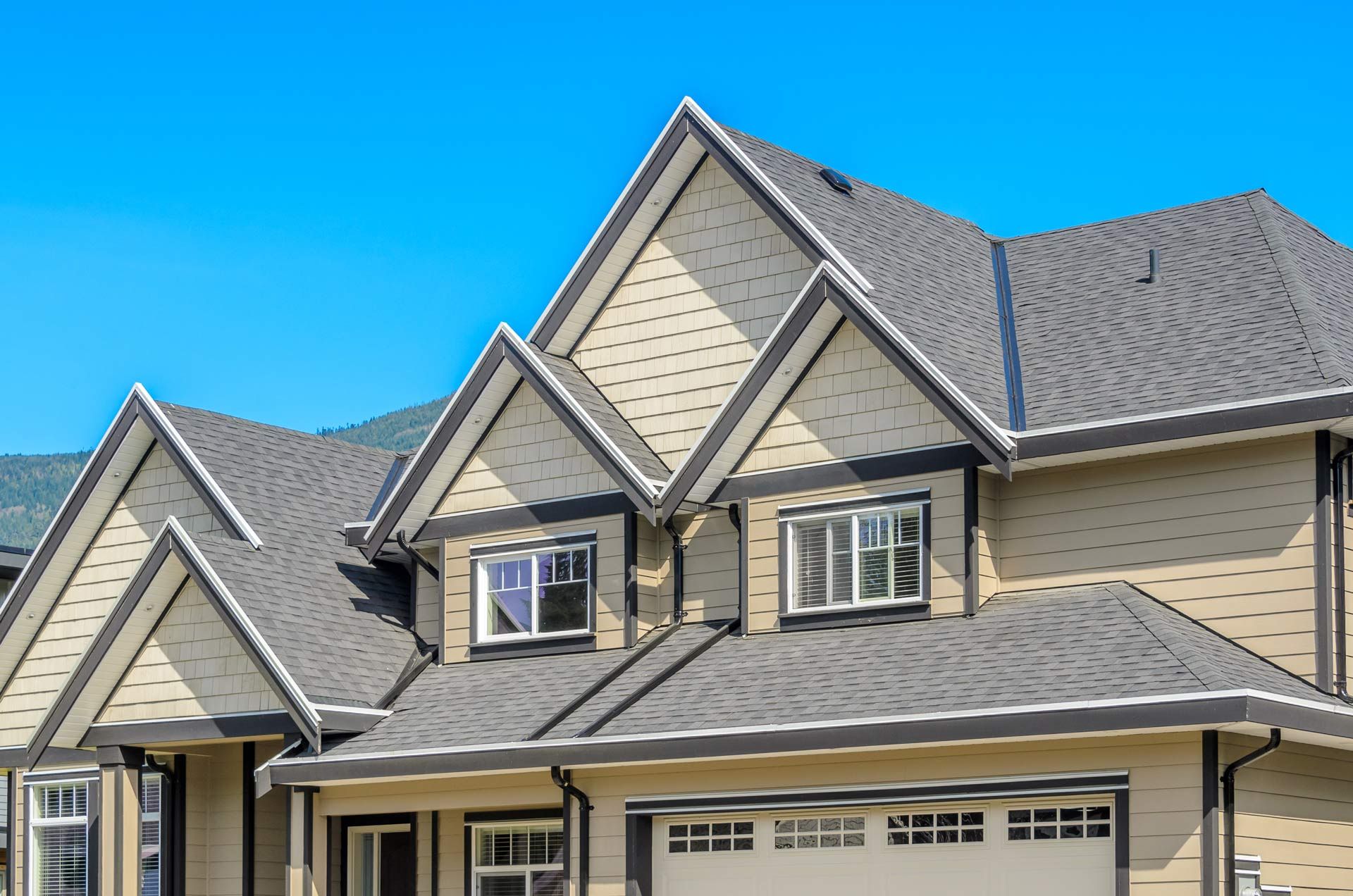A large house with a lot of windows and a gray roof