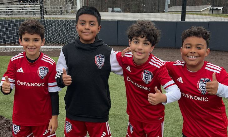 BEST FC soccer players posing and smiling on a field
