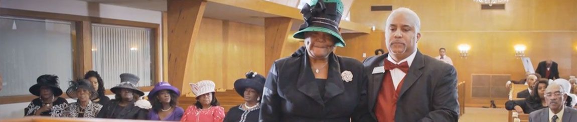 African American woman and man at a funeral in a church