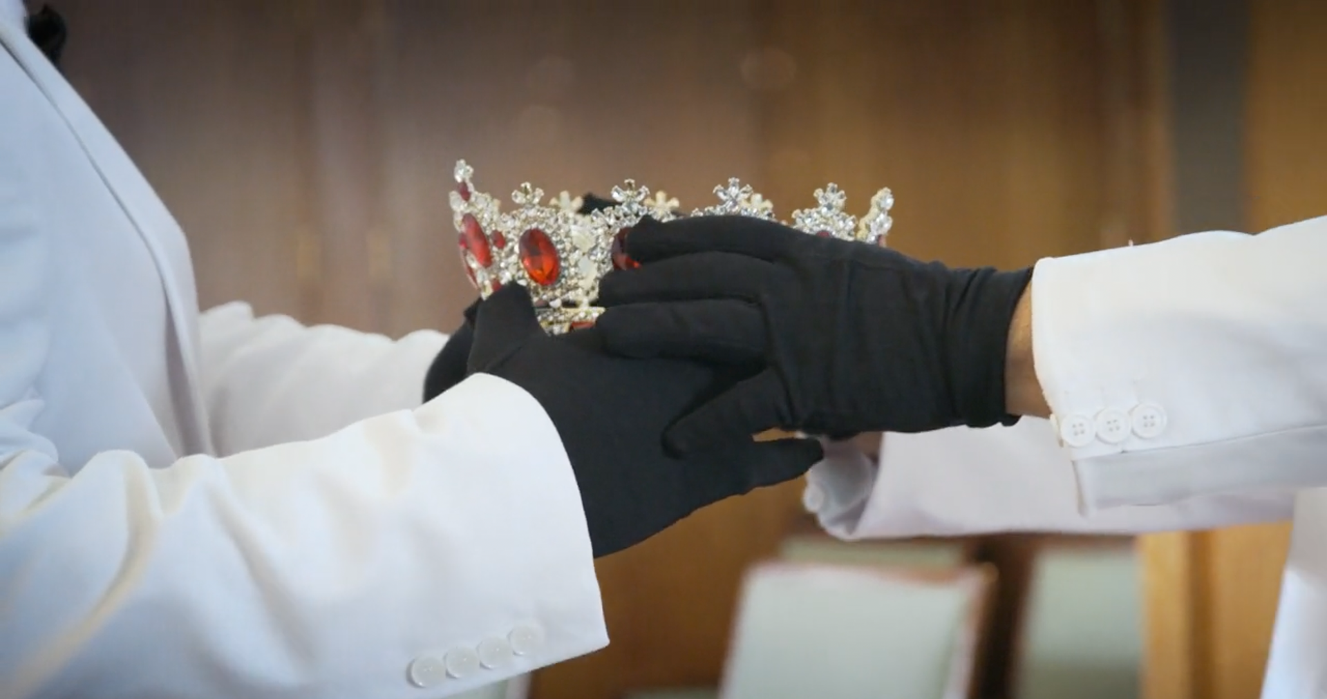 priests reading the bible over a flower-decorated casket