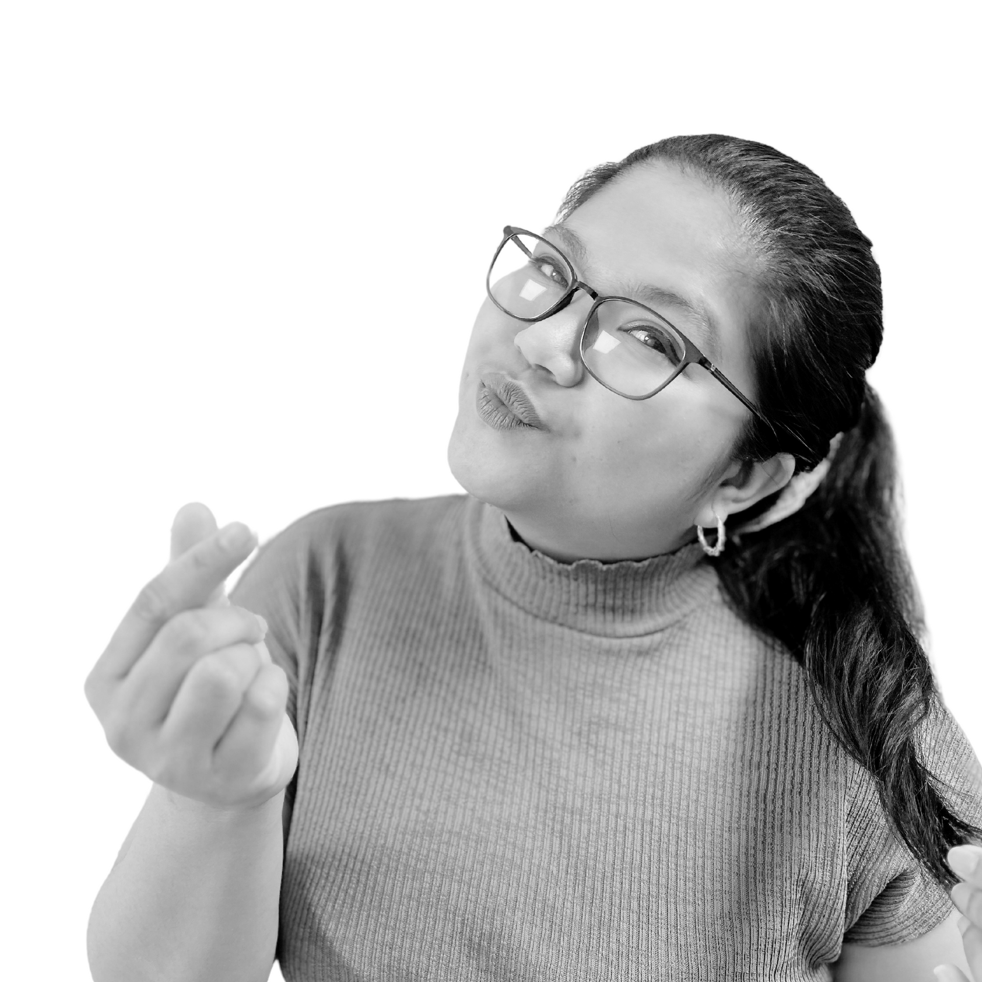 Woman in glasses, making a finger heart gesture with a playful expression.