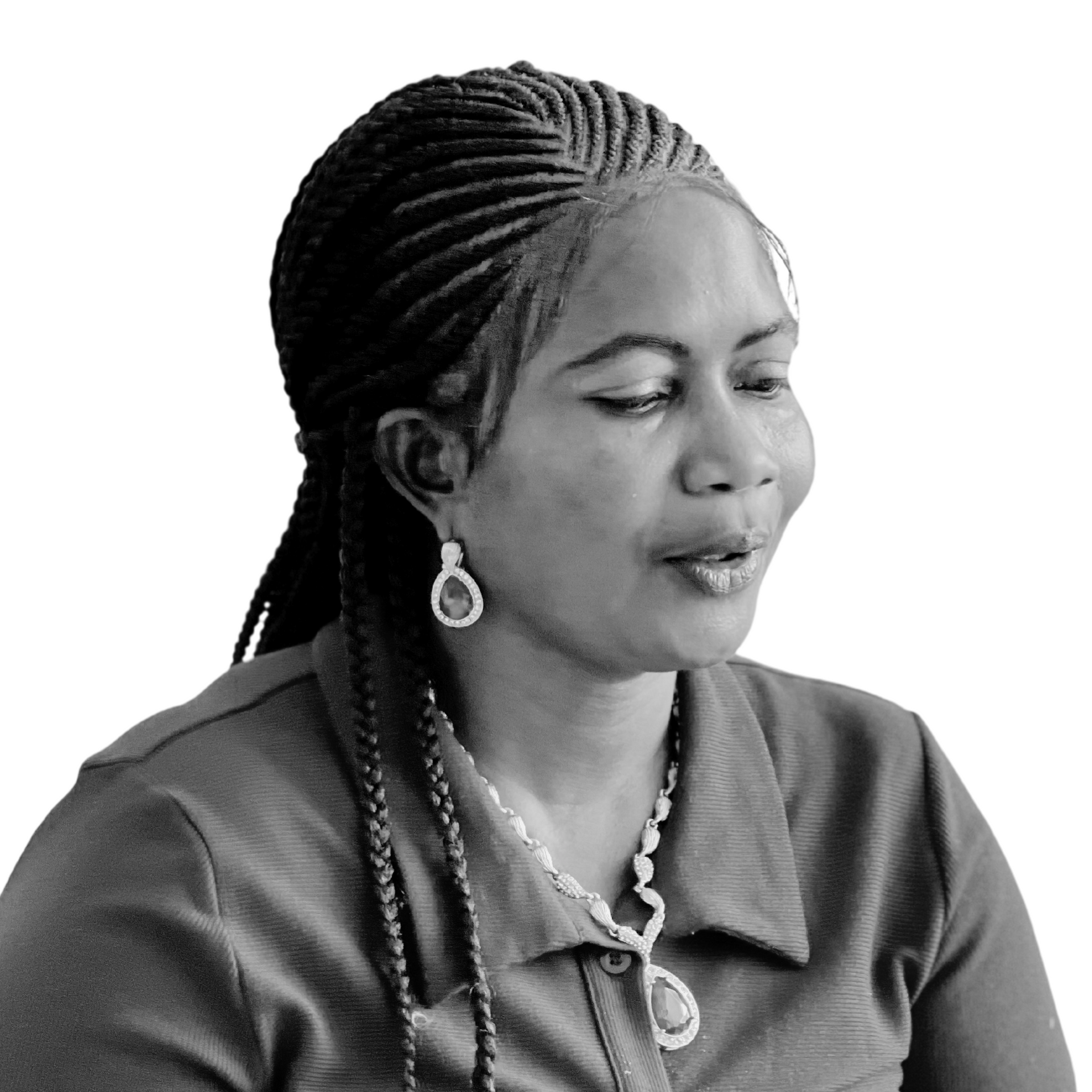 Woman with braided hair, wearing earrings and necklace, looking to the side.