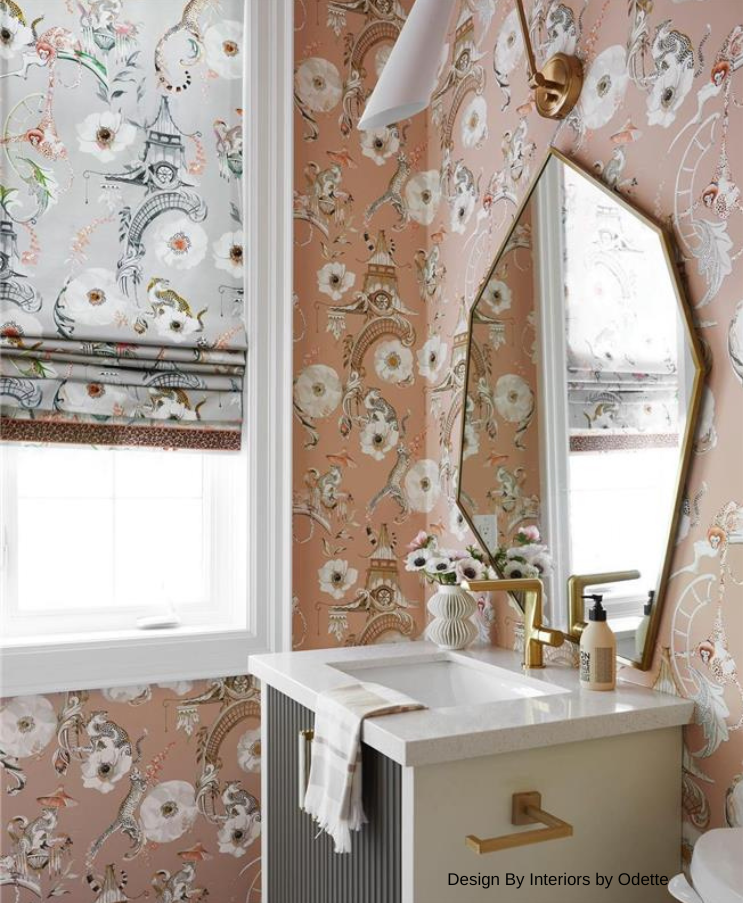 Powder room with floral wallpaper, gold fixtures, and a white sink.
