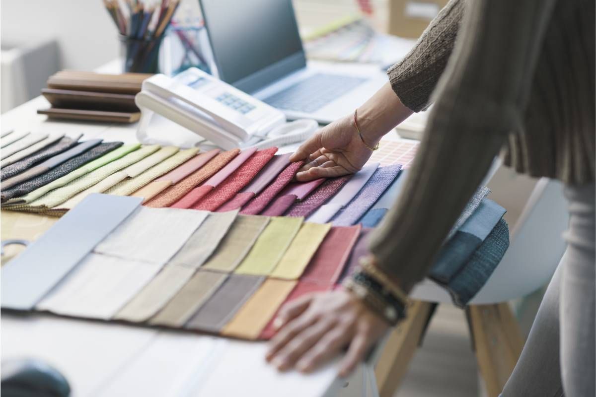 Interior Design looking through fabric swatches on her desk