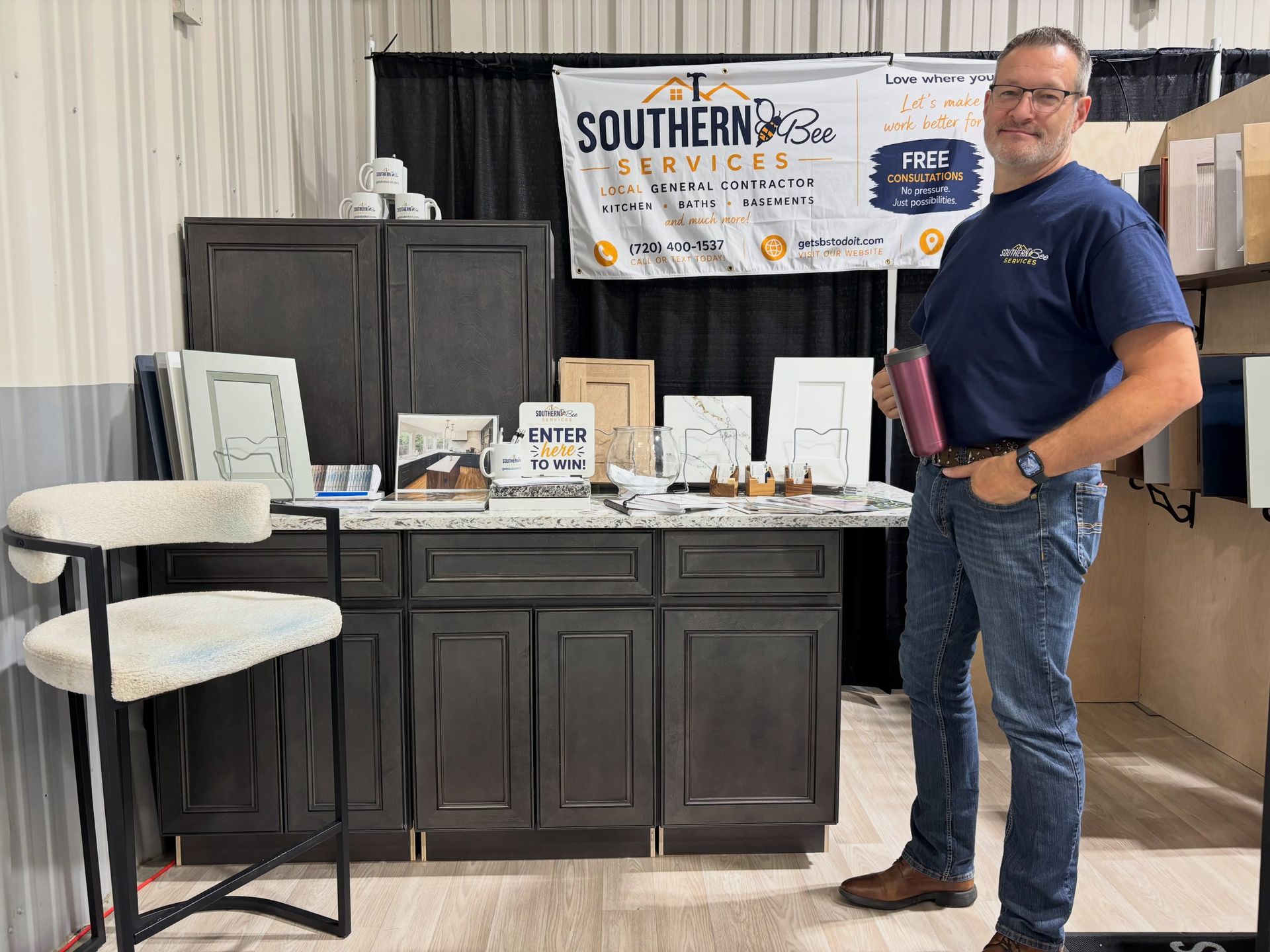 Trade show booth with display tables and a man standing beside product samples and a Southern-branded banner.