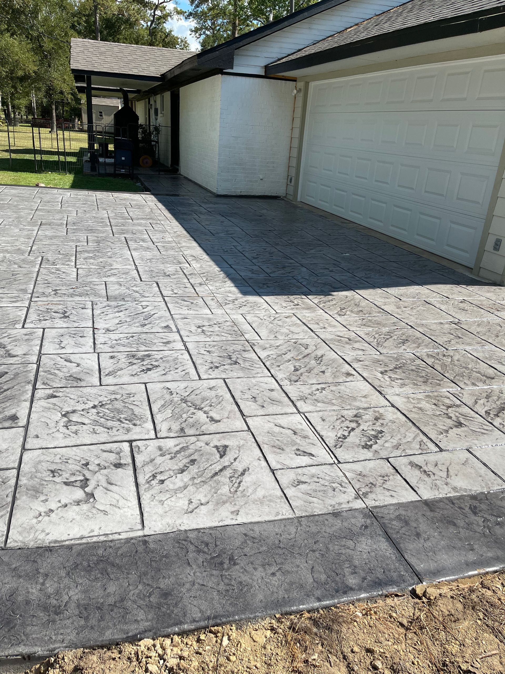 A large house with a concrete driveway in front of it