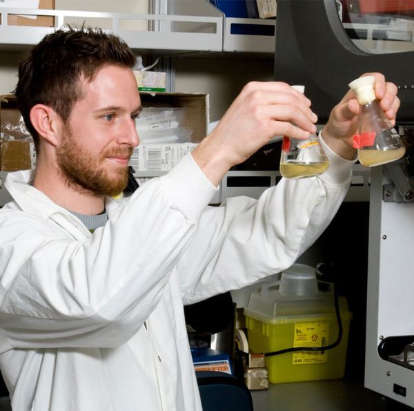 A researcher using test tubes.
