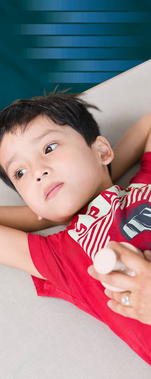 A young boy is lying down receiving treatment for his CF.