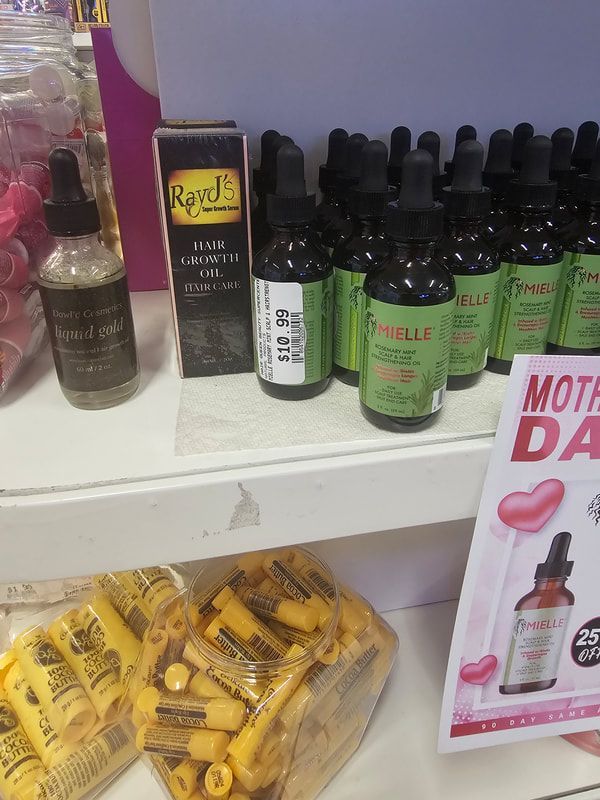 A shelf full of bottles and a sign that says moth day