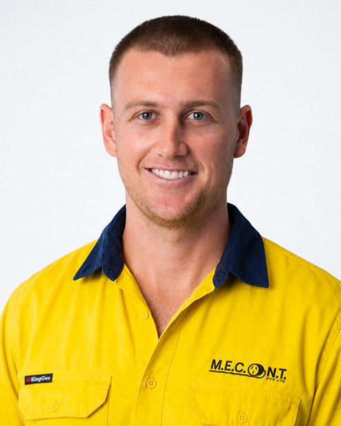 Smiling person in a yellow work shirt with a dark blue collar and company logo on a white background