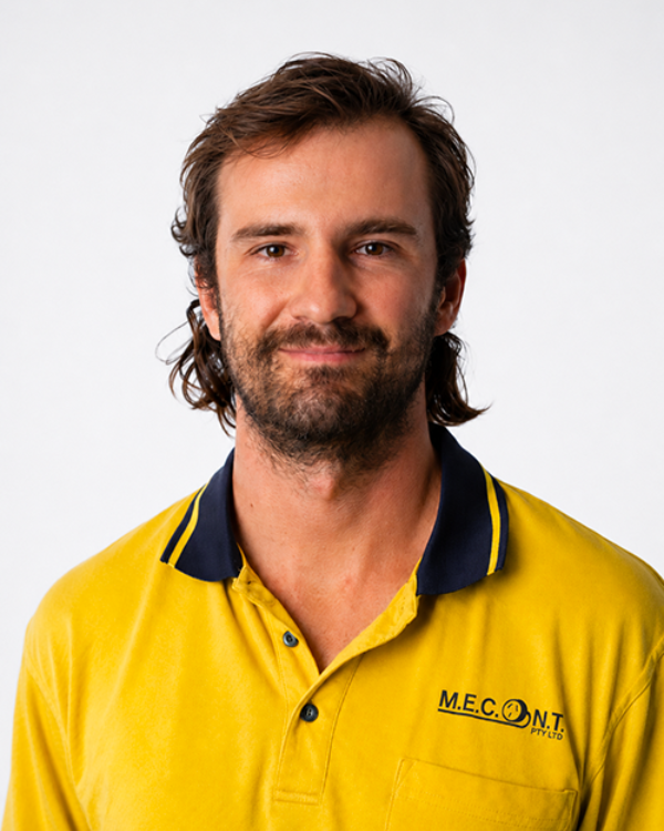 Portrait of a smiling man in a yellow polo shirt against a white background