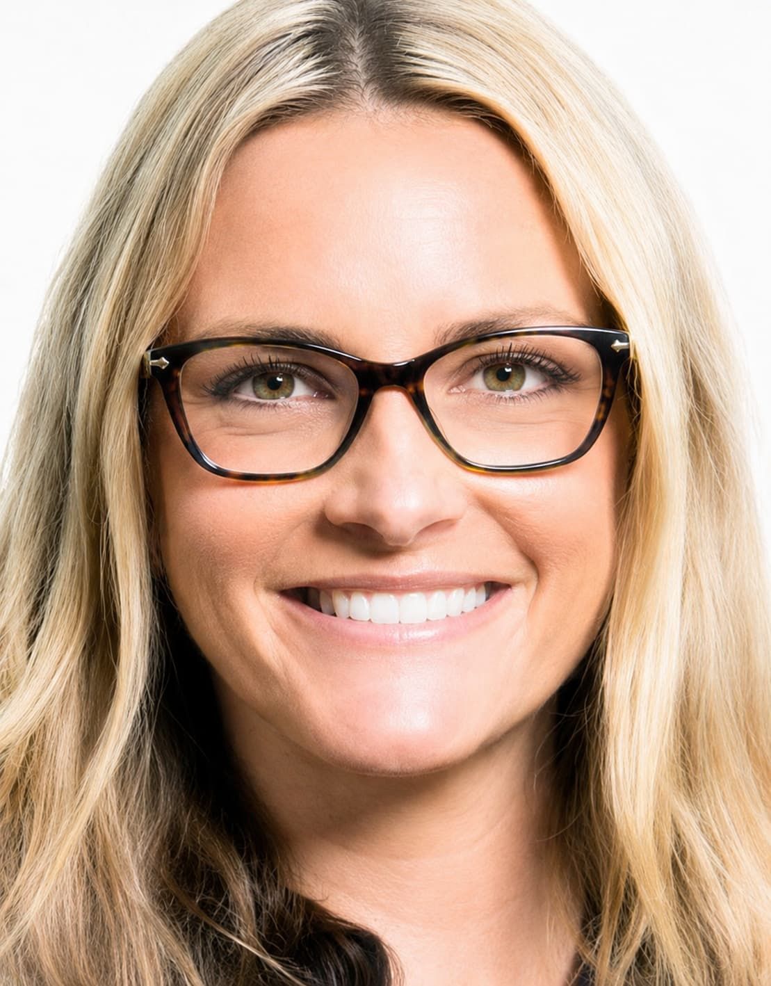 Smiling blonde person wearing black glasses on a white background