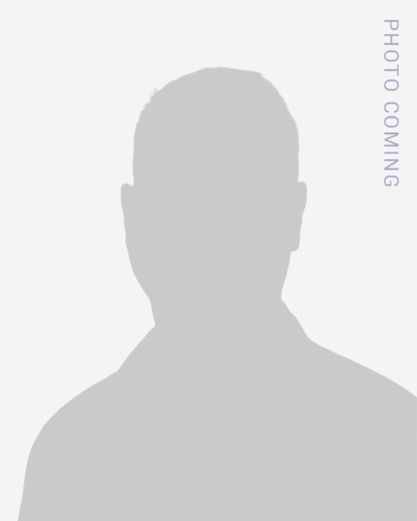 Gray placeholder silhouette avatar on a light background with vertical “PHOTO COMING” text