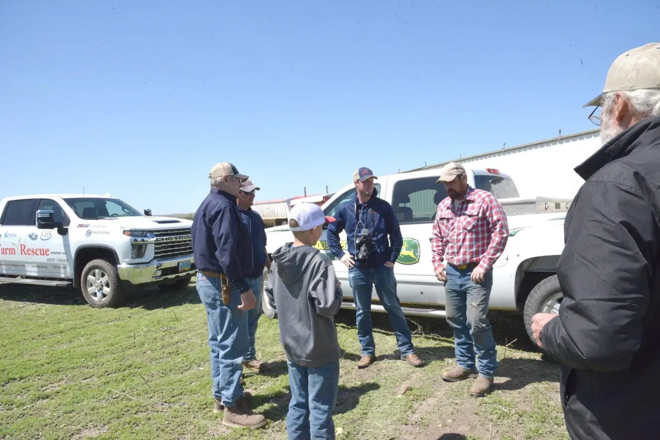 Farm Rescue employees talking to Stanley, North Dakota farmers