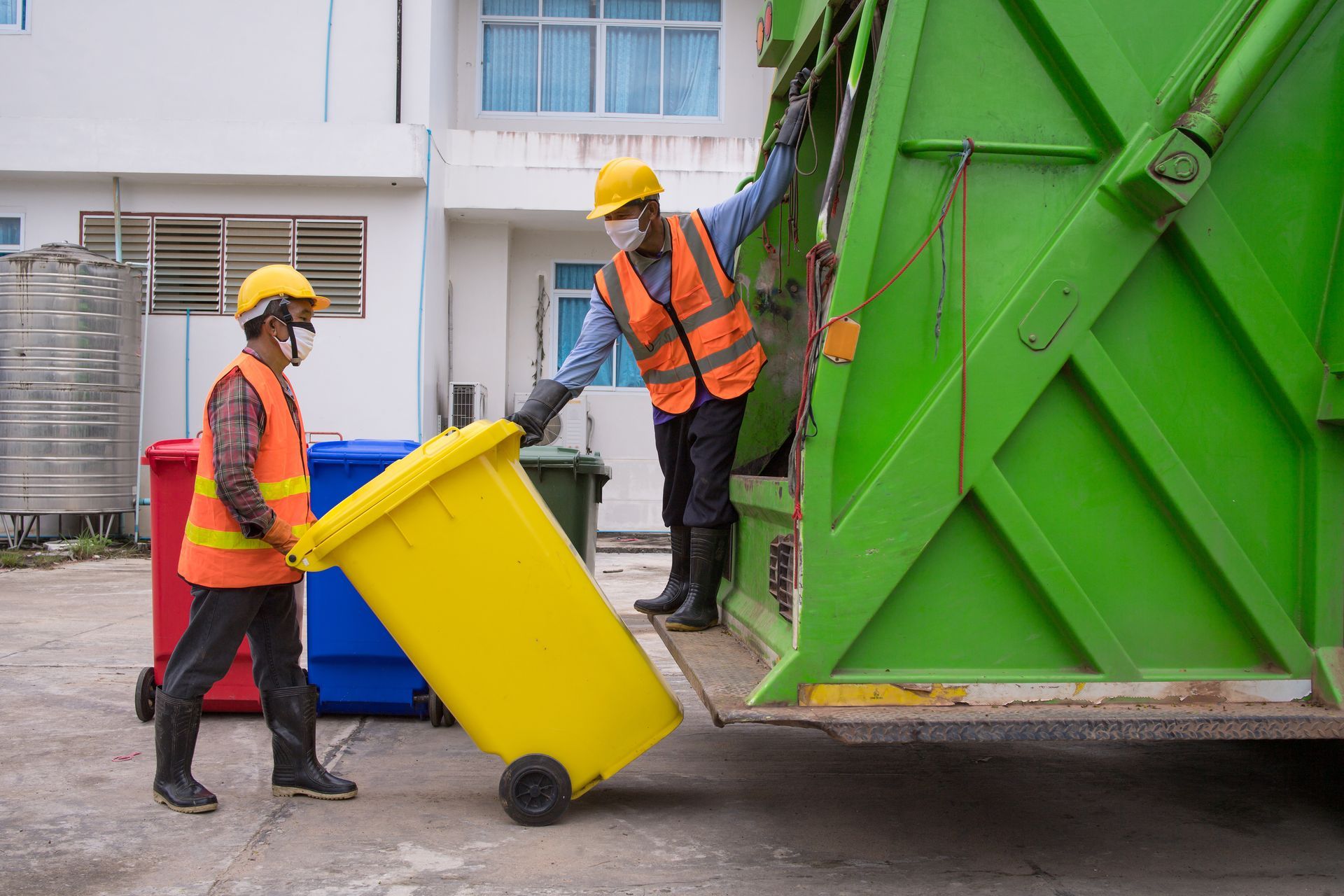 Two men are collecting garbage. Two men are collecting garbage.