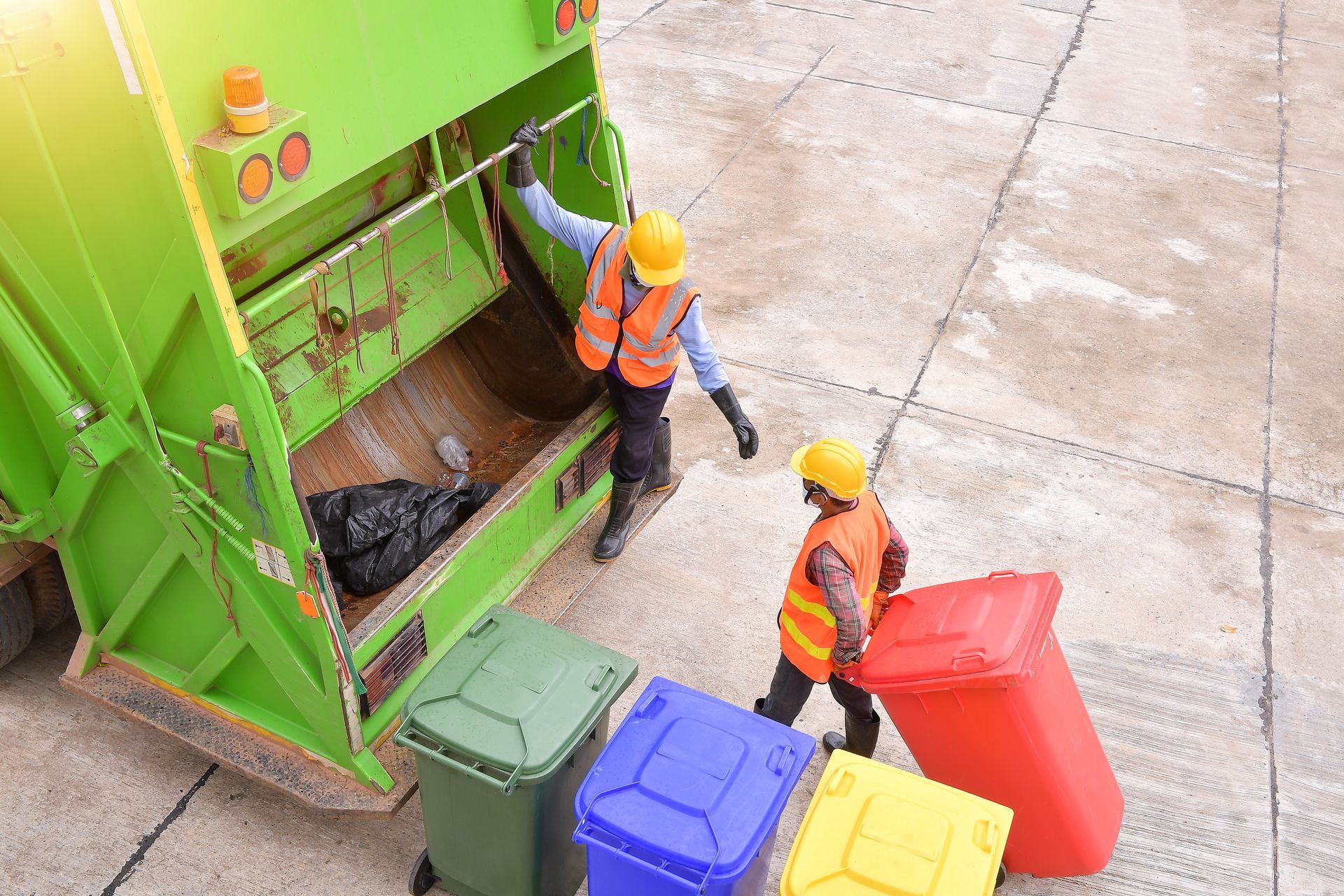 Two men are collecting garbage. Two men are collecting garbage.