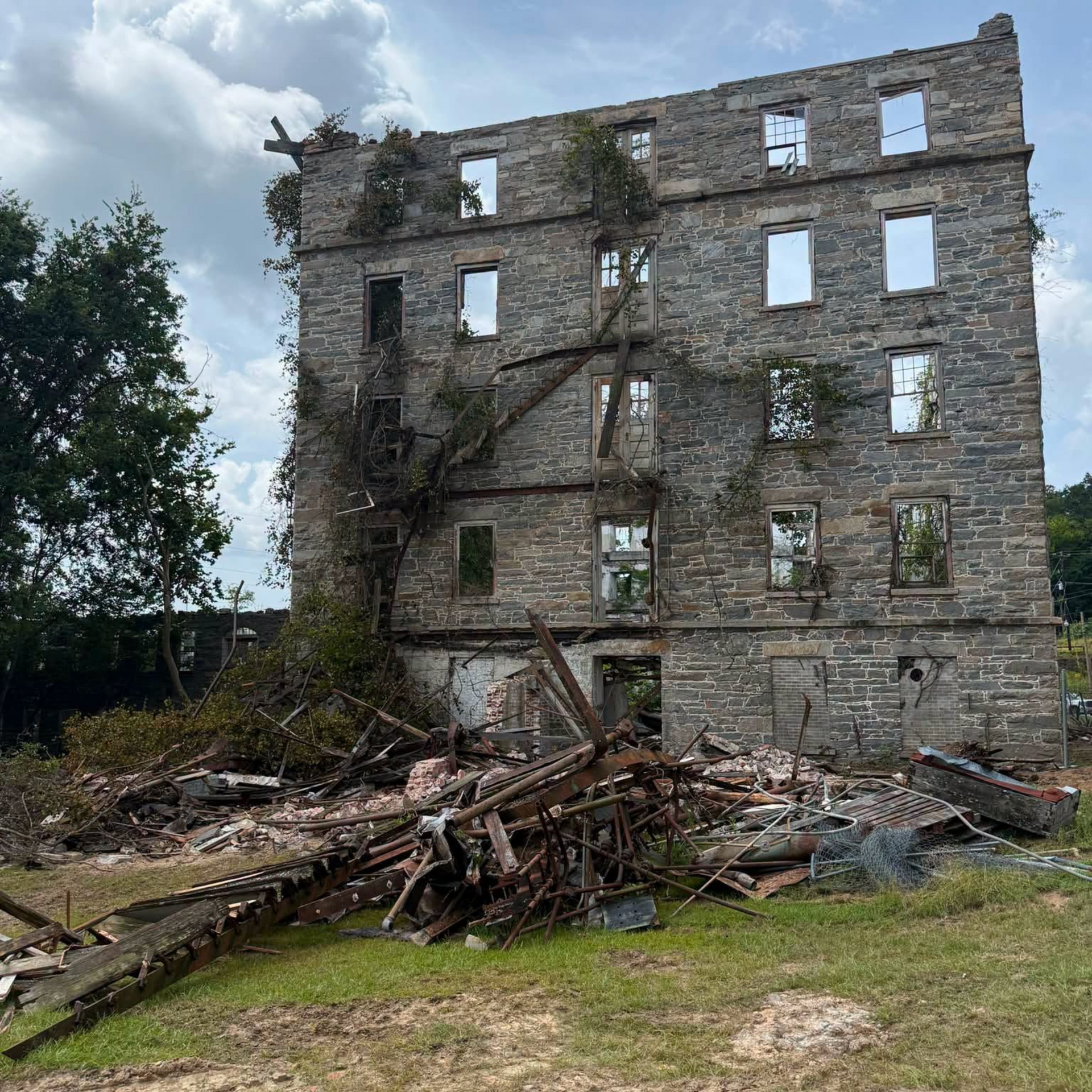 Historic 1852 Mill in Tallassee, Alabama, after tree and brush removal improved visibility around the former textile mill property.