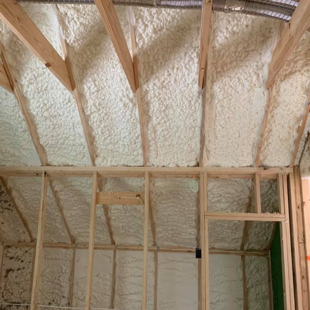the ceiling of a house is covered in foam and wooden beams .