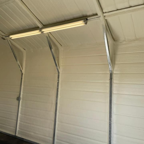a garage with white walls and a light on the ceiling .
