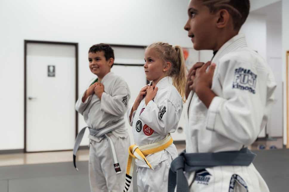 Kids practice controlled grappling in a Youth Jiu-Jitsu class at Academy of Jiu-Jitsu Scottsdale.