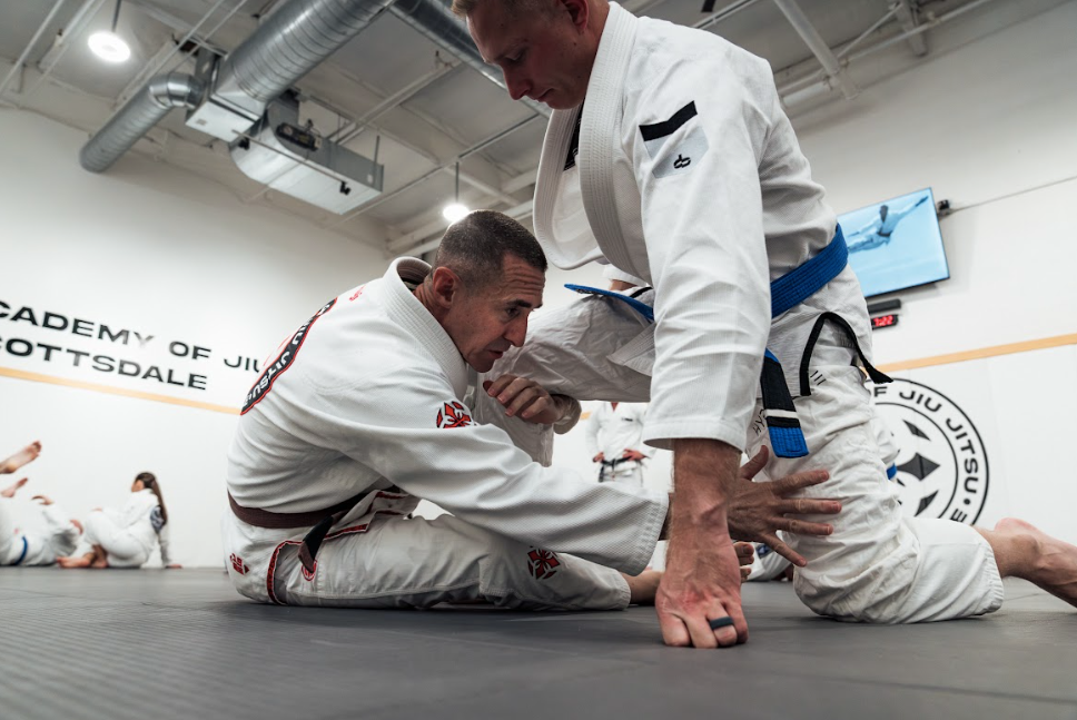 Beginners drill Brazilian Jiu-Jitsu fundamentals at Academy of Jiu-Jitsu Scottsdale in Scottsdale, AZ to build confidence.