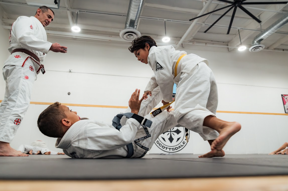 Kids practicing controlled grappling drills at Academy of Jiu-Jitsu Scottsdale in Scottsdale, AZ for confidence