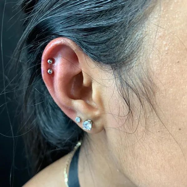 Woman's Ear with Multiple Earrings — San Diego, CA — Church Of Steel