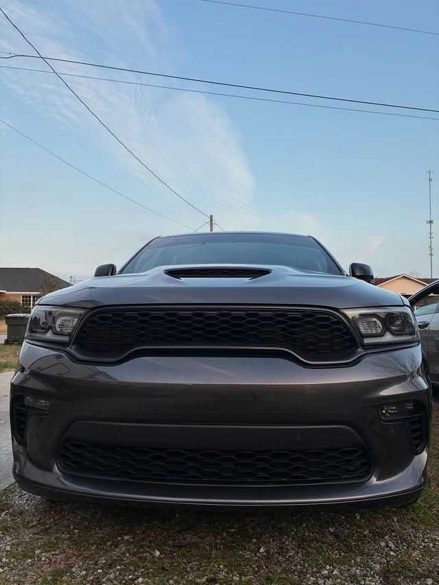 Dark gray Dodge Durango SUV with black grille and hood scoop, parked outside.