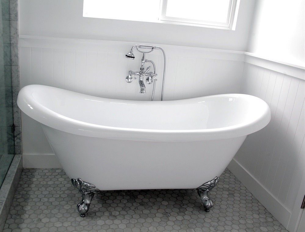 White clawfoot bathtub in a bathroom, with chrome fixtures and a window.