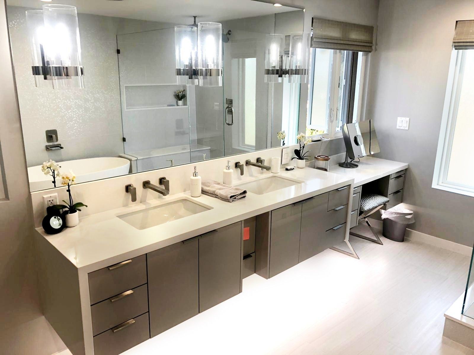 Modern bathroom with double sinks, large mirror, vanity, and neutral color scheme.
