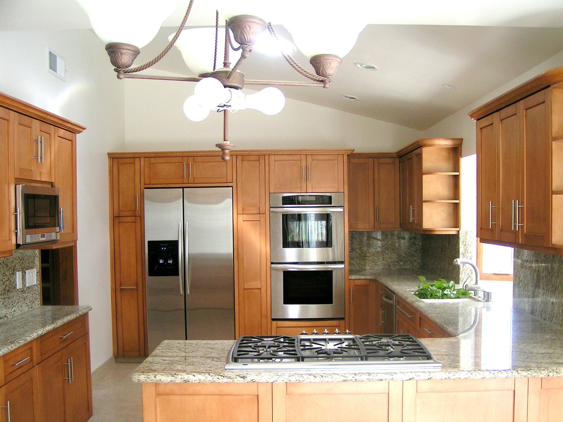 Kitchen with wood cabinets, stainless steel appliances, and granite countertops.