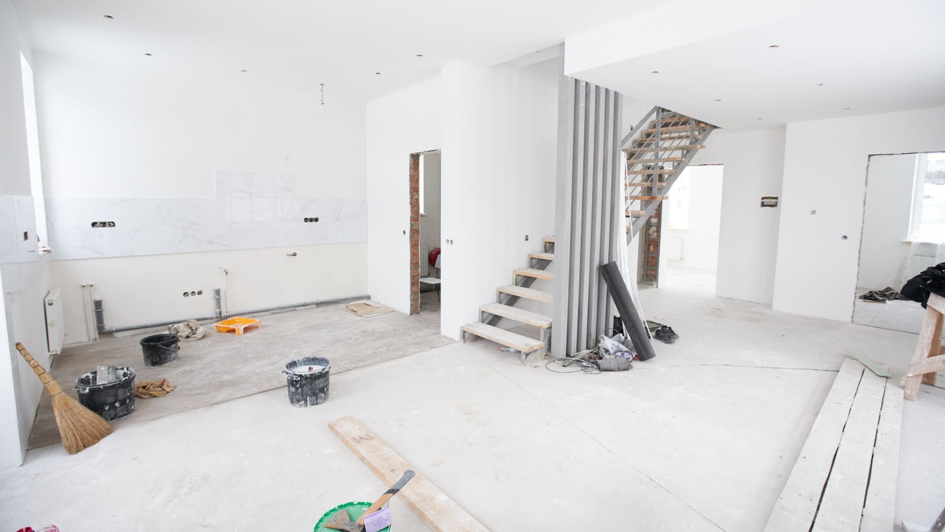 An empty room with a staircase in the middle of it.