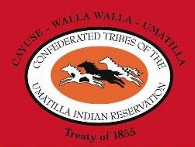 Confederated Tribes of the Umatilla Indian Reservation logo. Red background, oval with three running horses, text.