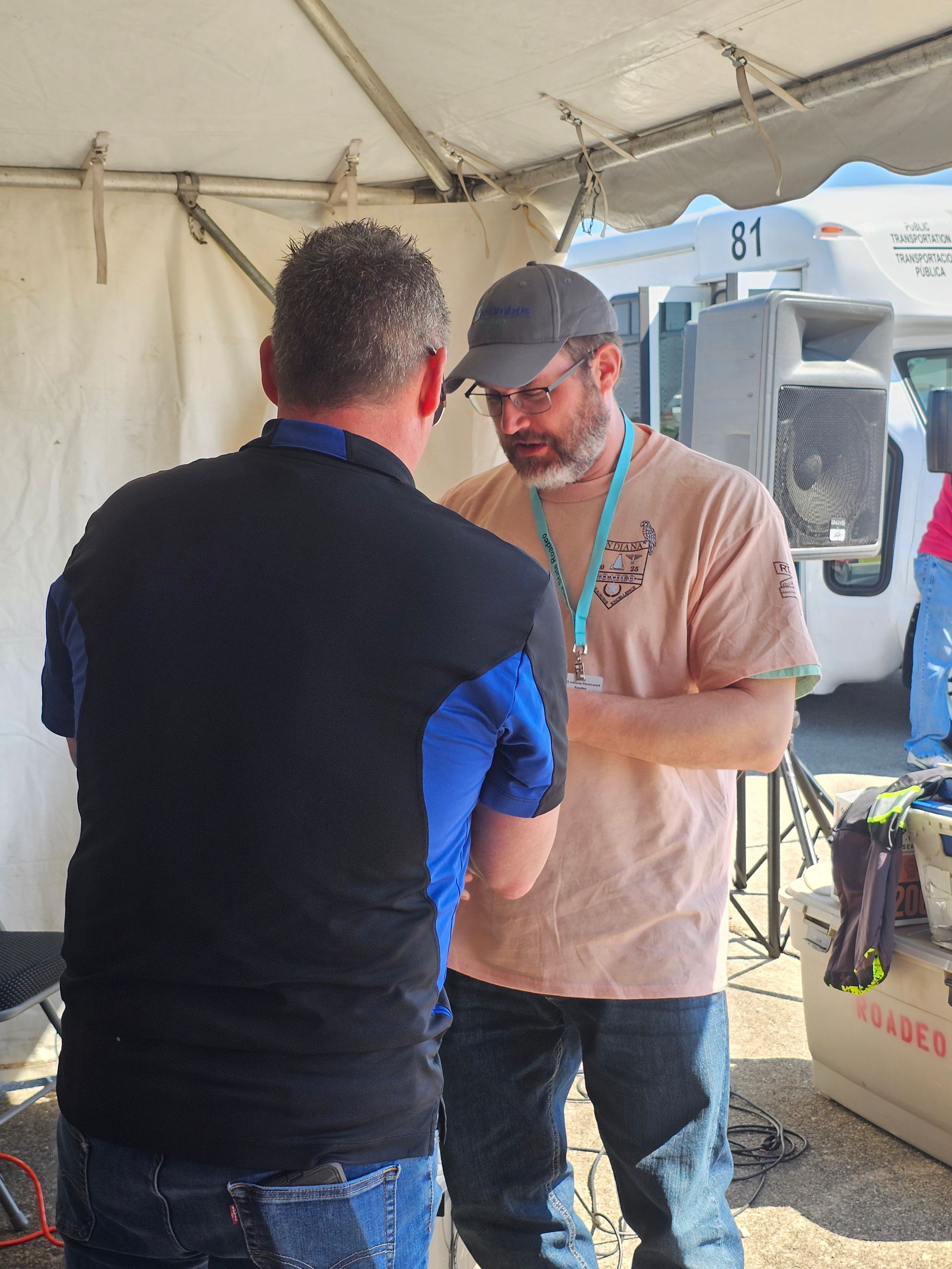 Two people talking under a tent