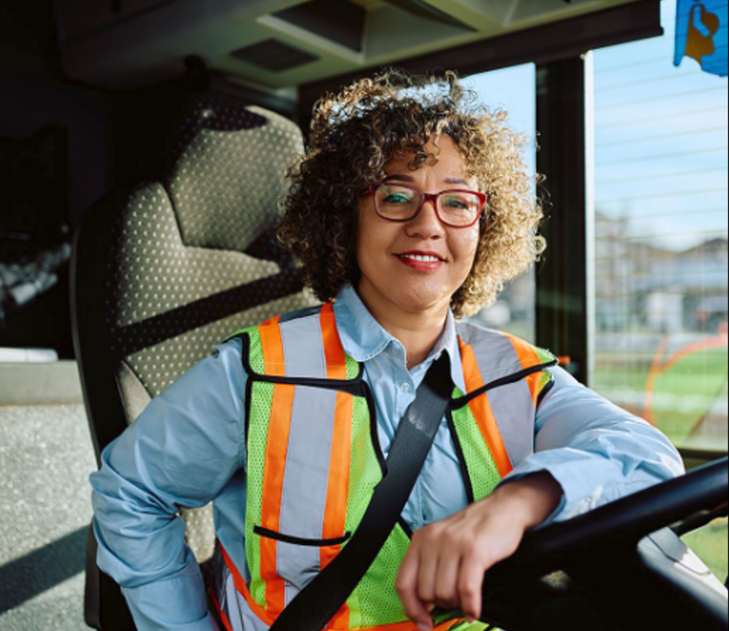Driver smiling with her hand on the wheel