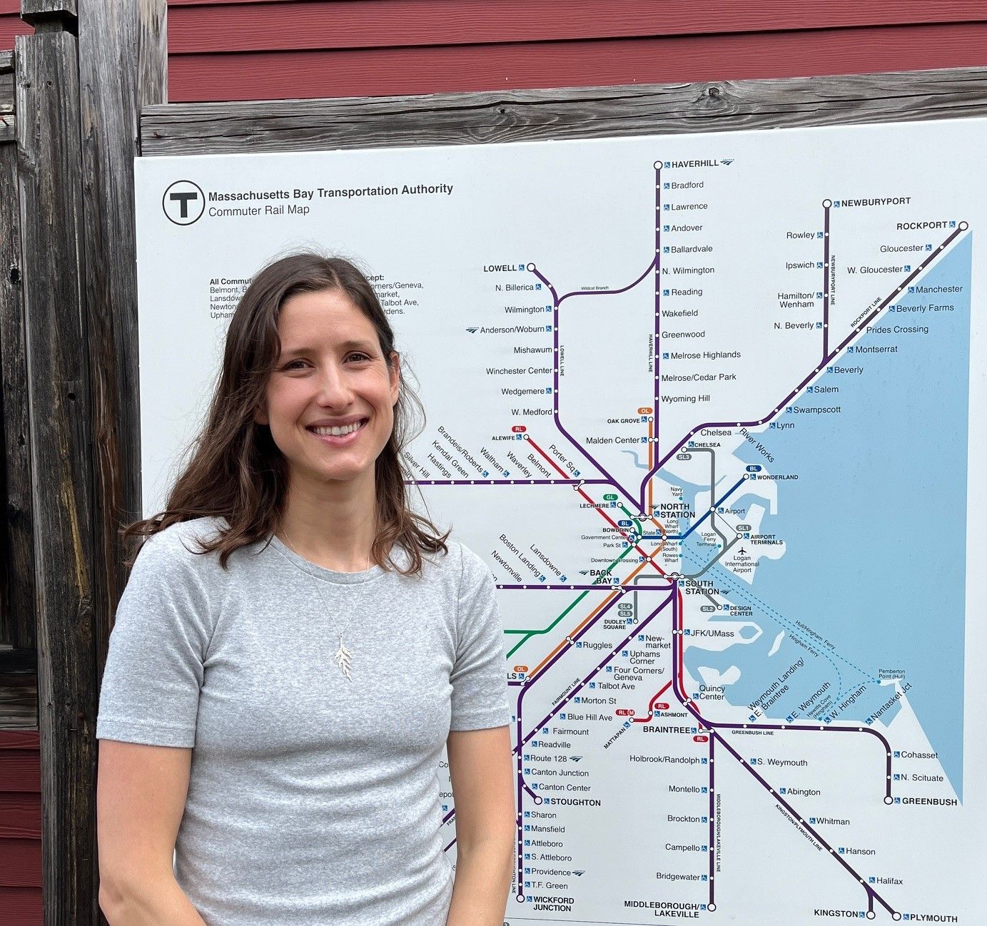 Liz Taylor standing in front of an MBTA sign