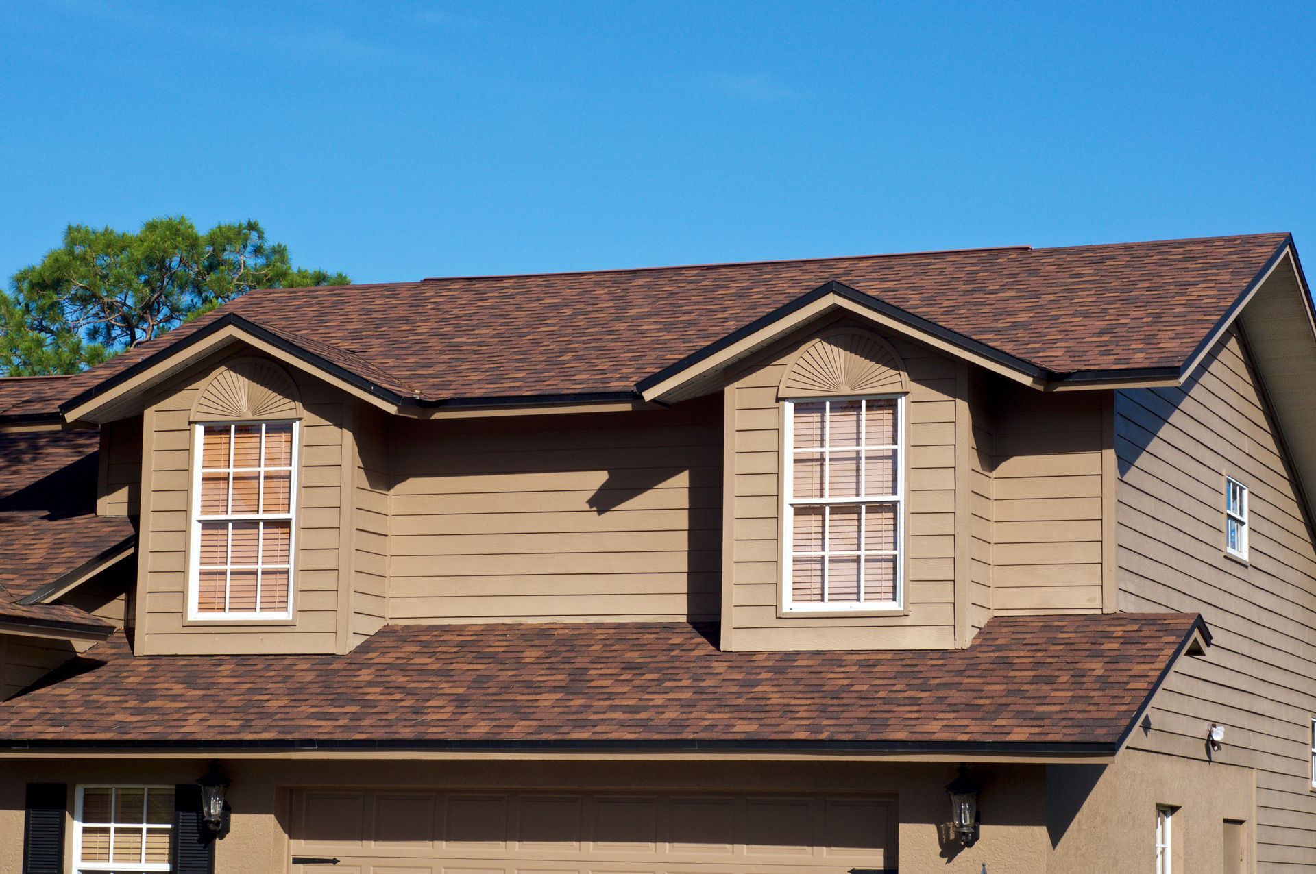 a house with brown siding and a brown roof
