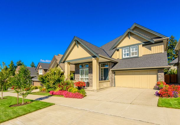 a large house with a large driveway in front of it .