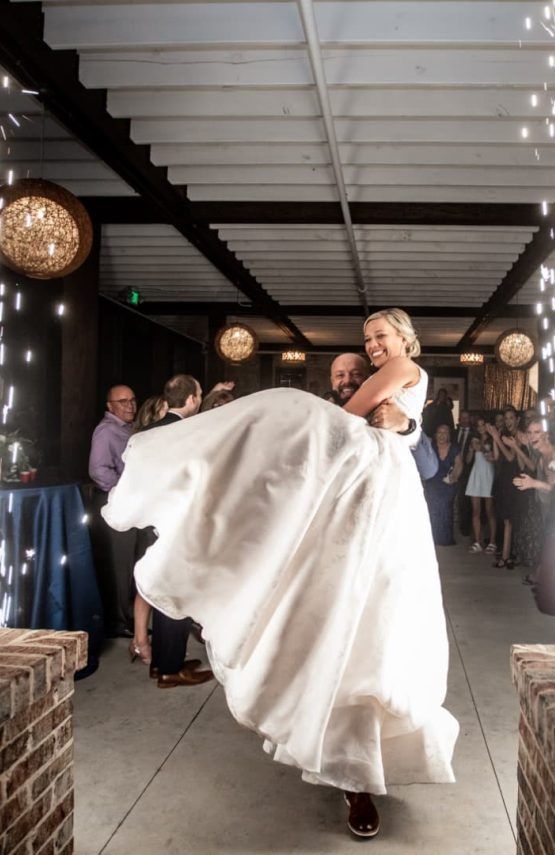 A bride and groom are dancing at their wedding reception.