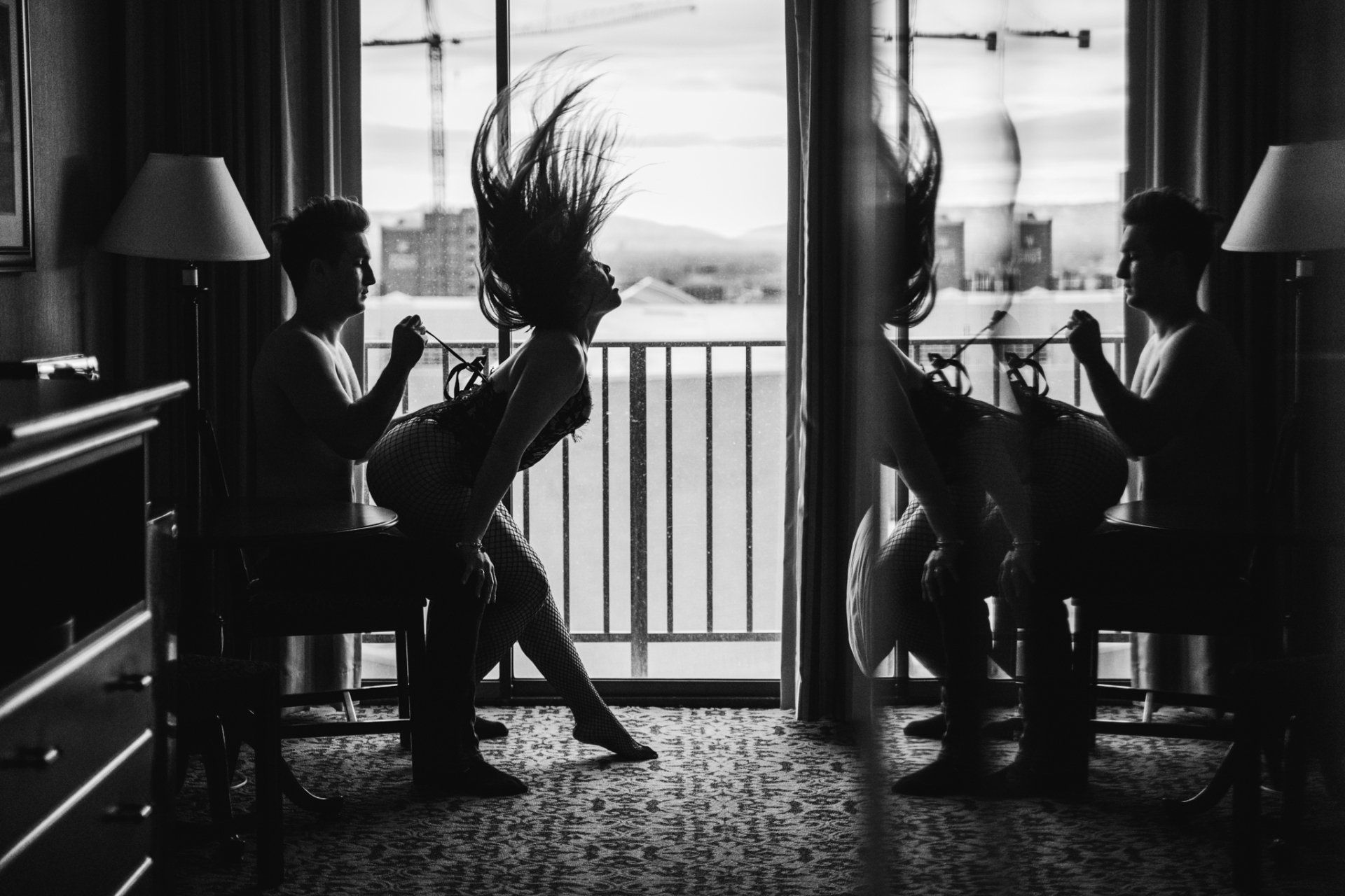 A couple in a room, captured in black and white.