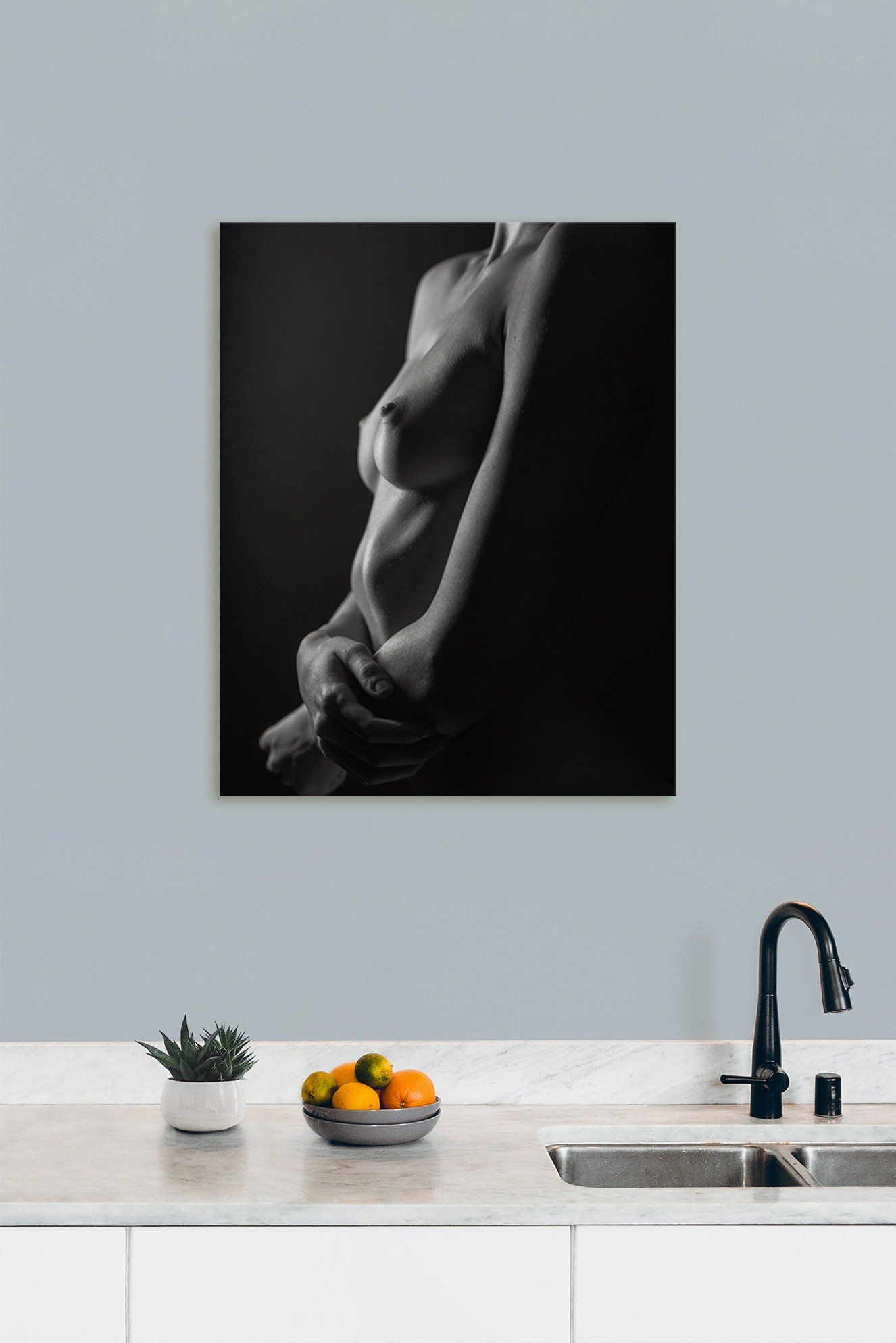 Modern kitchen featuring a hanging photo on the wall, adding a personal touch to the sleek design.