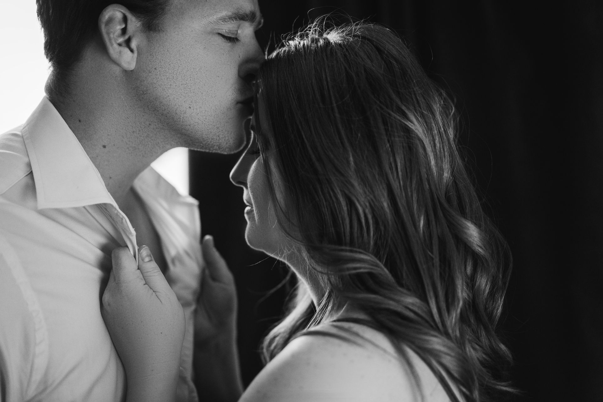 A man kissed his partner on the forehead.