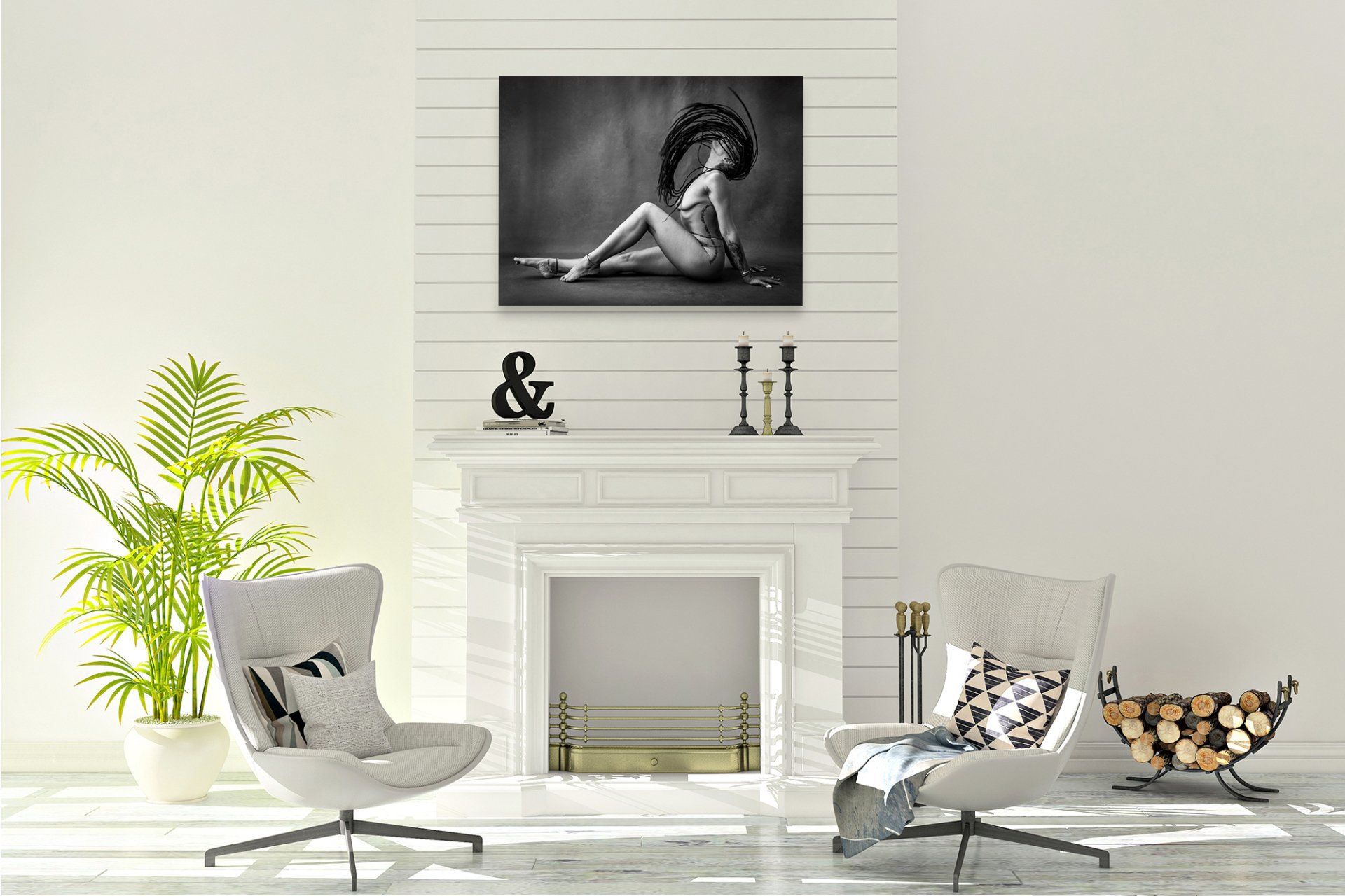 A spacious room with white walls and wooden floors. It showcases various framed prints and artwork on display.