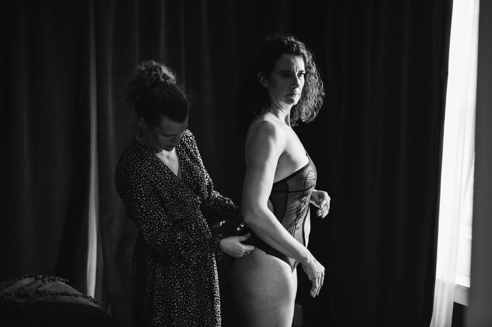 A woman measuring her body with a tape measure.