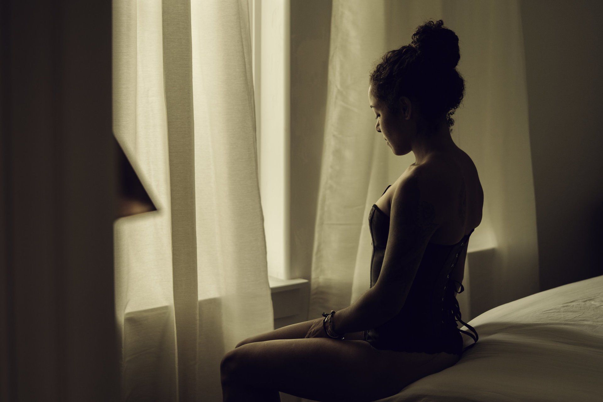 woman sitting on bed