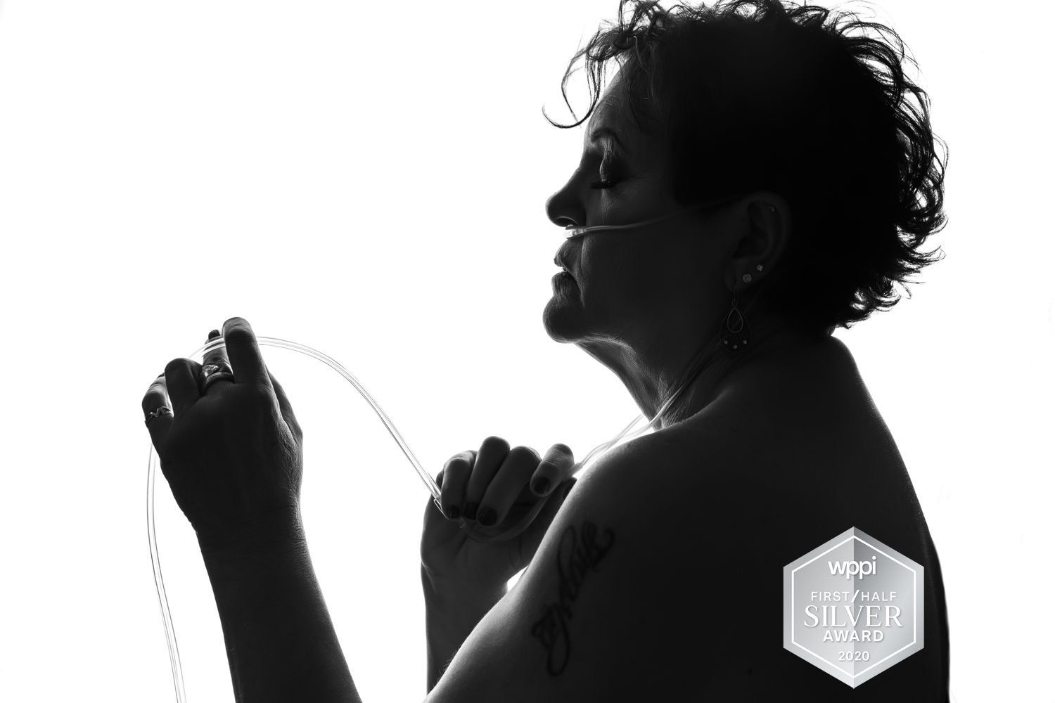 black and white photograph of a woman with oxygen mask