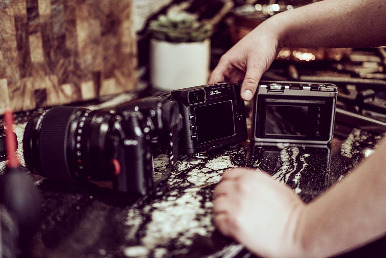 three cameras and hands